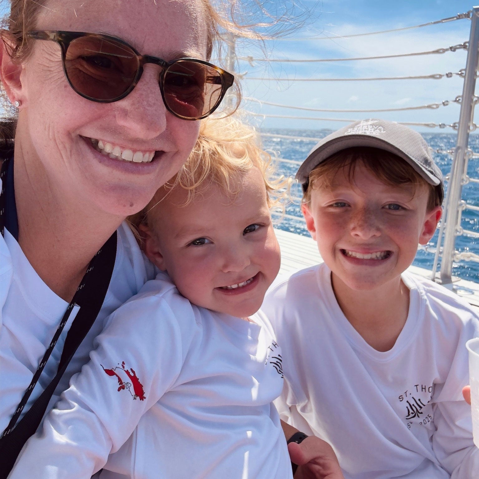 White long sleeve UPF50+ recycled polyester sun shirt featuring the “Turtles and Tacos” design with tropical turtles and an outline of St. Thomas filled with a dive flag on the sleeve. Customizable front and back text. Available in sizes 2T to adult, hooded or crewneck style.